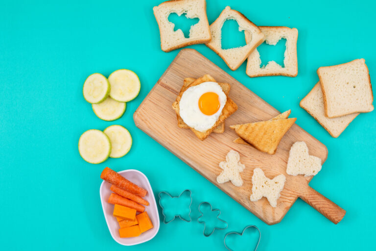 Top view fried egg with toasts vegetables blue surface horizontal